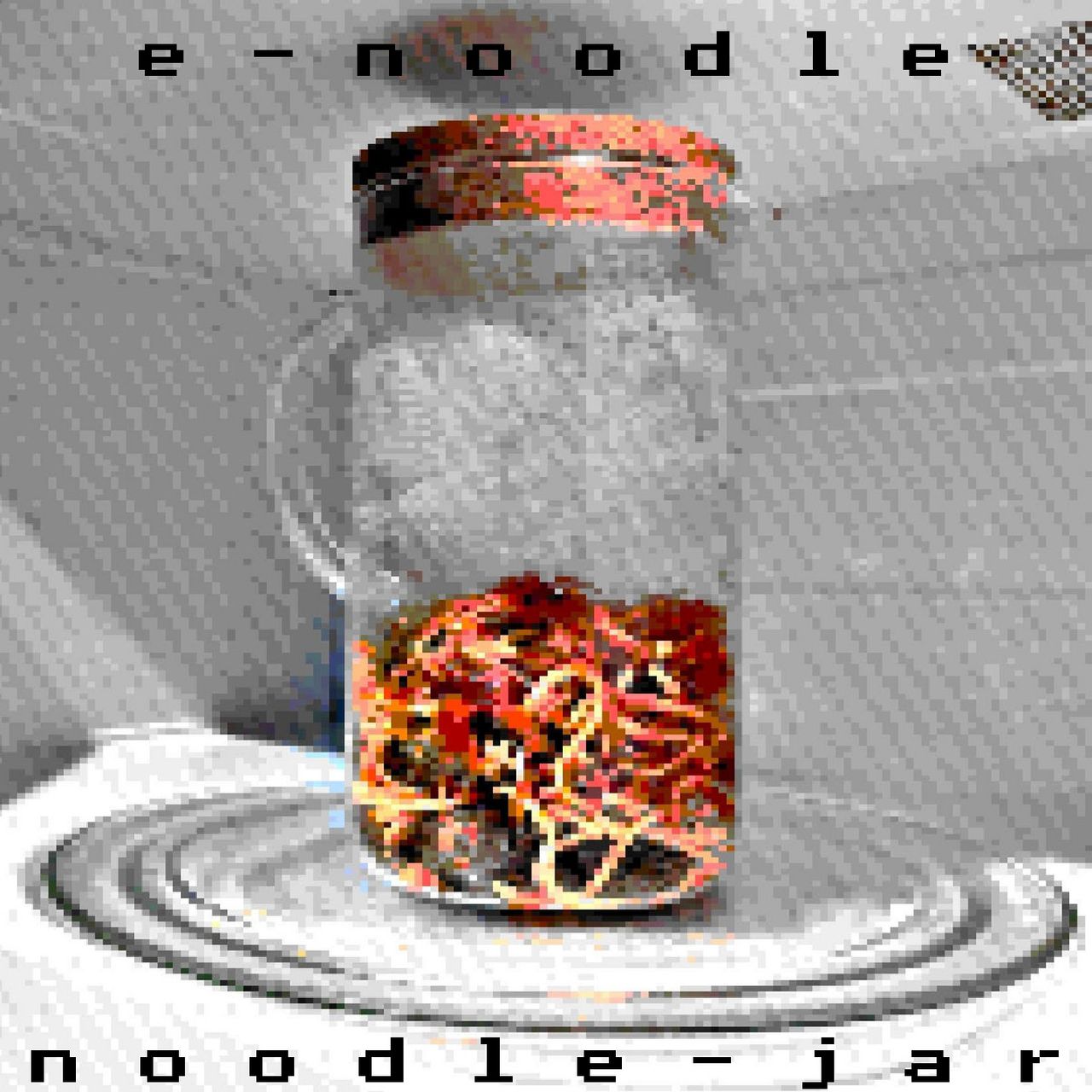 noodle jar release cover. low resolution glass jar of spaghetti in a microwave.