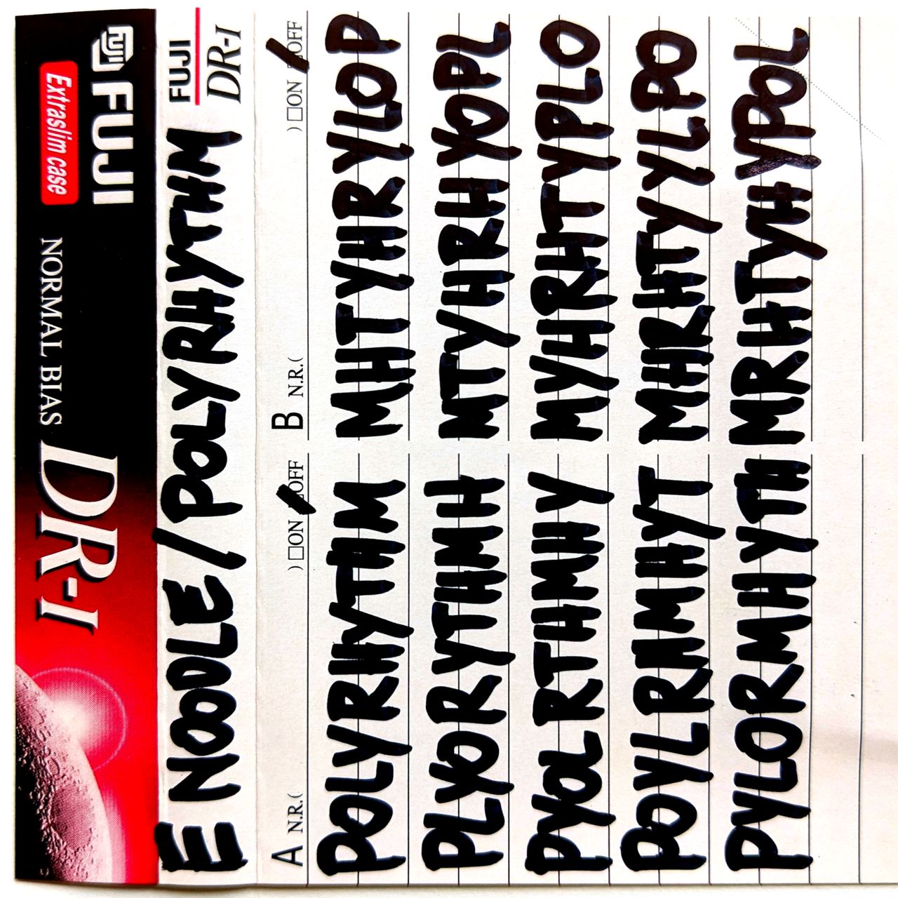 polyrhythm fuji dr-1 release cover. cassette j-card with hand-written anagrams of title track.